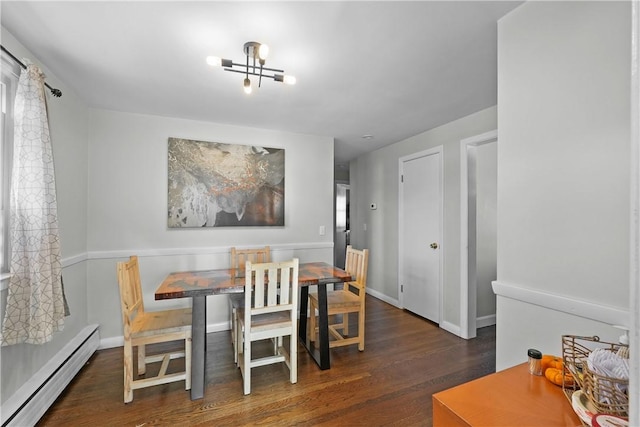 dining space featuring a notable chandelier, dark hardwood / wood-style floors, and a baseboard heating unit