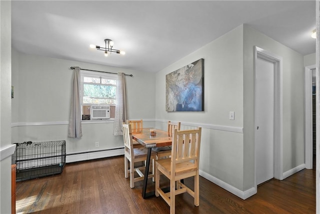 dining room featuring cooling unit, dark hardwood / wood-style flooring, and a baseboard radiator