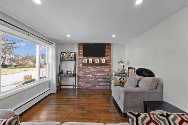 living room with baseboard heating and dark wood-type flooring