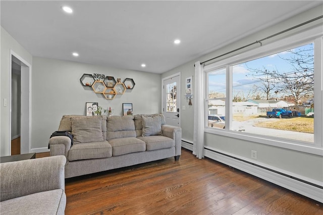 living room featuring dark hardwood / wood-style flooring and a baseboard radiator