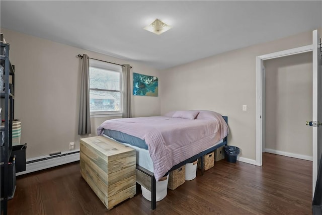 bedroom featuring baseboard heating and dark hardwood / wood-style floors