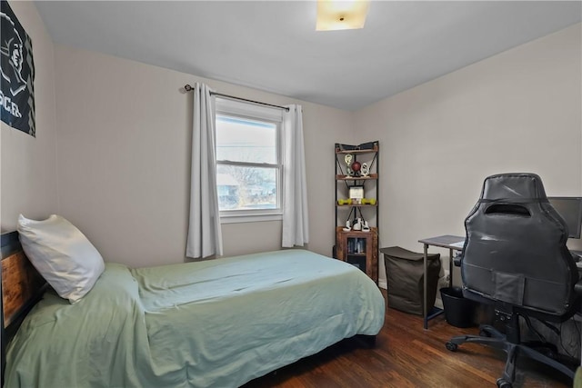 bedroom with dark wood-type flooring