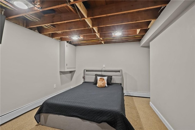 bedroom featuring light colored carpet and a baseboard heating unit