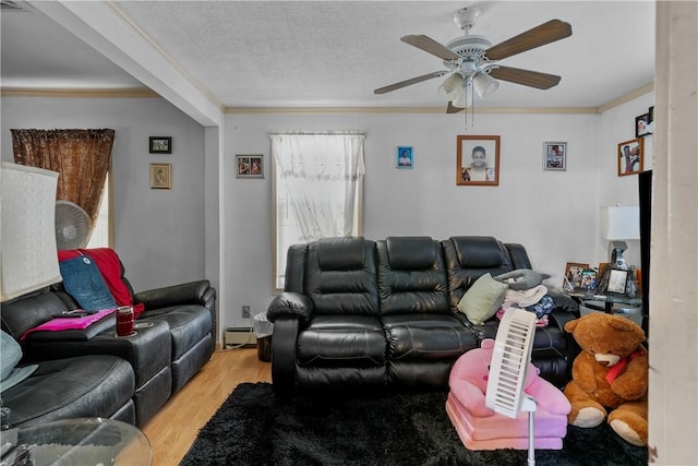 living room with light hardwood / wood-style flooring, ceiling fan, ornamental molding, a textured ceiling, and a baseboard radiator