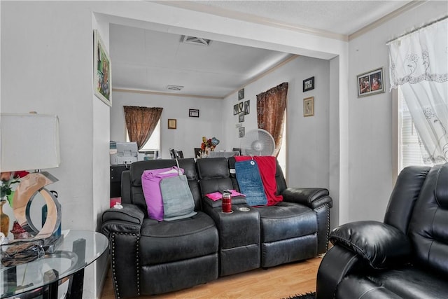 home theater room with hardwood / wood-style flooring and crown molding