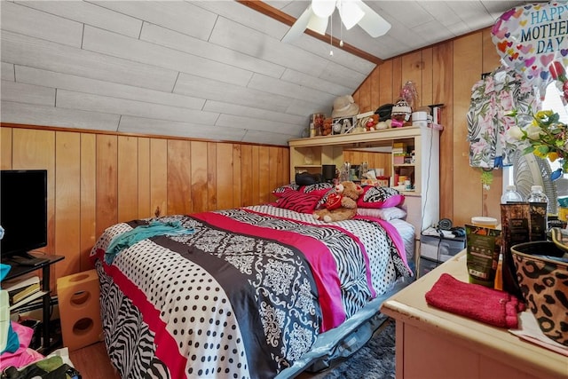 bedroom with lofted ceiling, ceiling fan, wooden walls, and wood ceiling