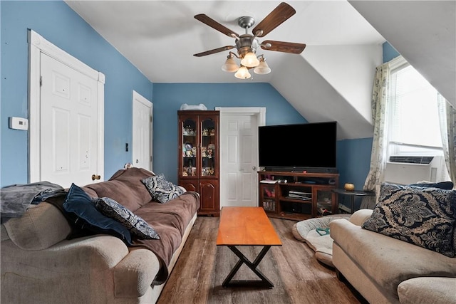 living room with ceiling fan, cooling unit, dark wood-type flooring, and vaulted ceiling