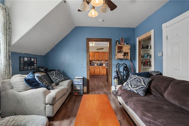 living room with ceiling fan, dark hardwood / wood-style flooring, built in features, and lofted ceiling