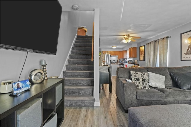 living room featuring ceiling fan and light hardwood / wood-style floors