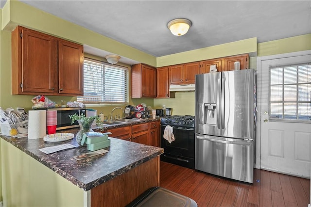 kitchen with dark wood-type flooring, sink, and stainless steel appliances