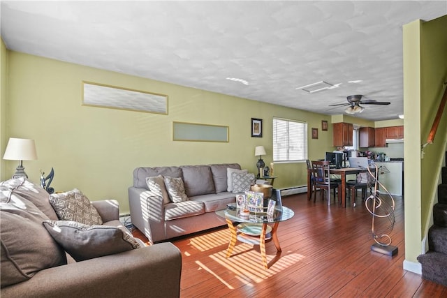 living room with ceiling fan and dark wood-type flooring