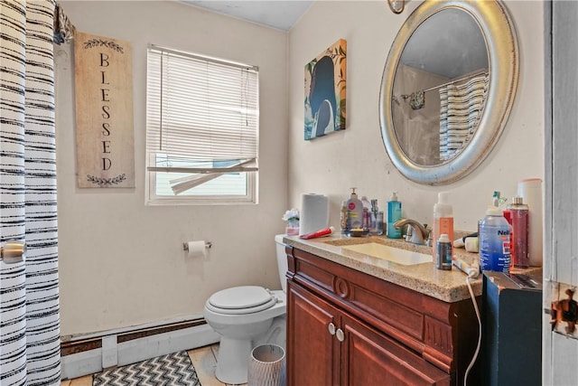 bathroom featuring vanity, a baseboard radiator, and toilet