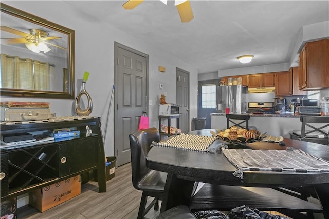 dining room featuring ceiling fan and light hardwood / wood-style flooring