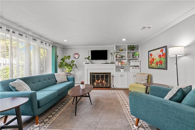 living room with hardwood / wood-style flooring and ornamental molding