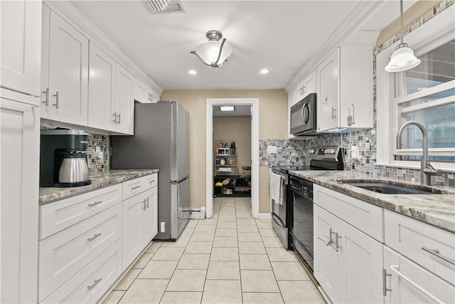 kitchen with light stone countertops, sink, decorative light fixtures, white cabinets, and black appliances