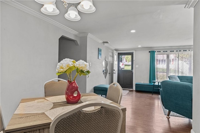 dining space featuring dark hardwood / wood-style flooring and crown molding