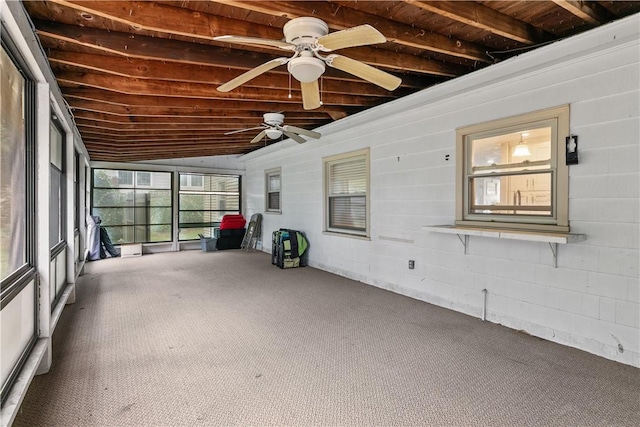 unfurnished sunroom with ceiling fan and vaulted ceiling