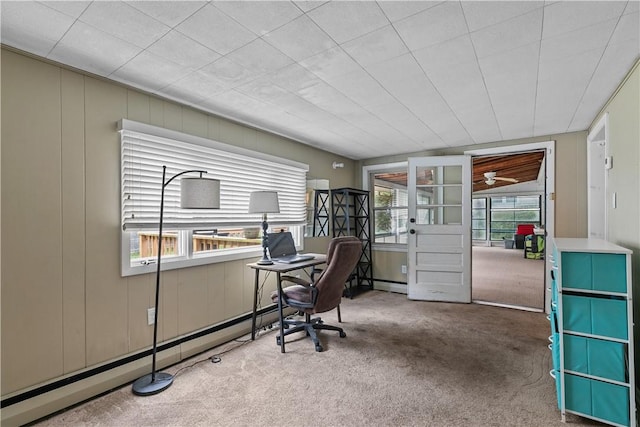 office area featuring carpet flooring, ceiling fan, and a baseboard radiator