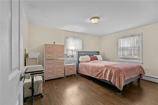 bedroom with a baseboard radiator and dark wood-type flooring