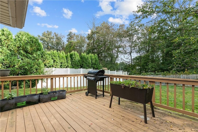 wooden deck with grilling area and a yard