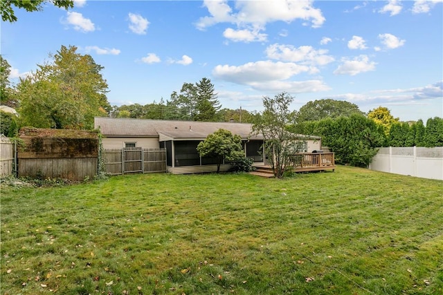 back of house featuring a yard and a wooden deck