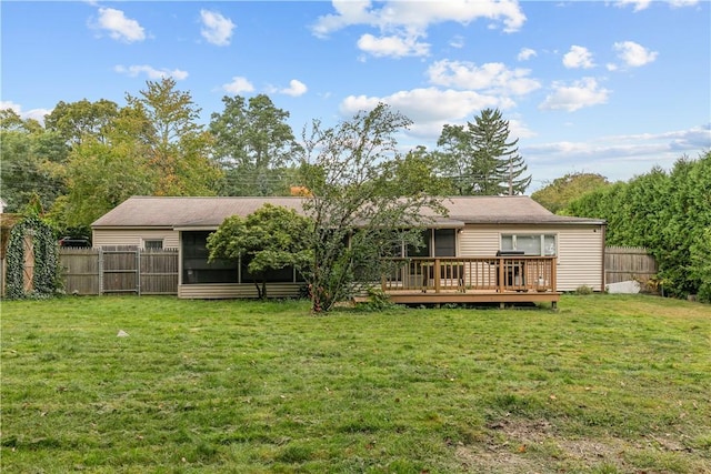 rear view of house with a yard and a deck