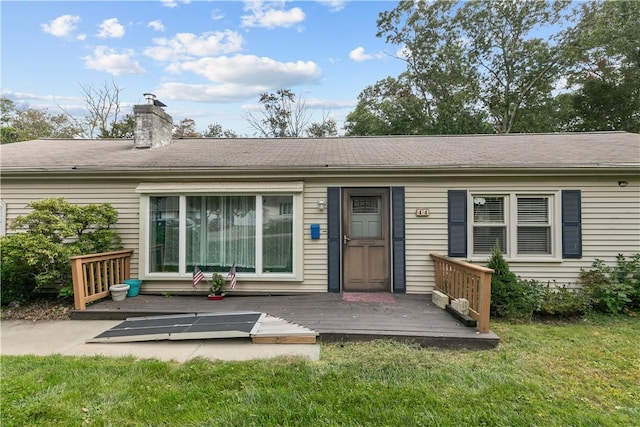 back of house featuring a yard and a wooden deck