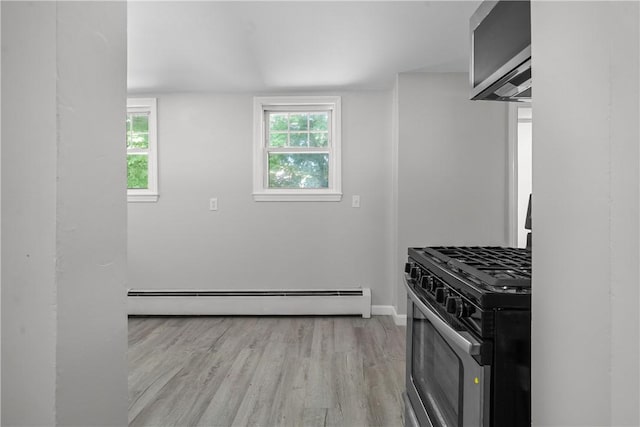 kitchen featuring gas range, light wood-type flooring, and a baseboard heating unit