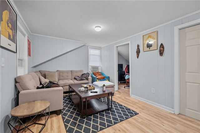 living room featuring hardwood / wood-style flooring and crown molding