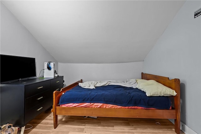 bedroom with light hardwood / wood-style flooring and vaulted ceiling