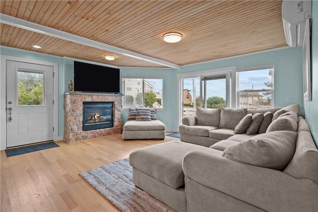 living room with a fireplace, beam ceiling, light hardwood / wood-style floors, and wooden ceiling