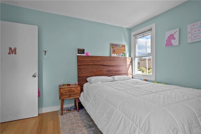 bedroom featuring wood-type flooring and multiple windows