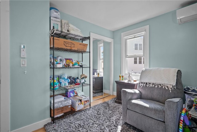 living area featuring a wall mounted air conditioner