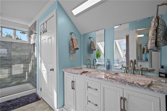 bathroom with vanity, a shower with door, and lofted ceiling with skylight