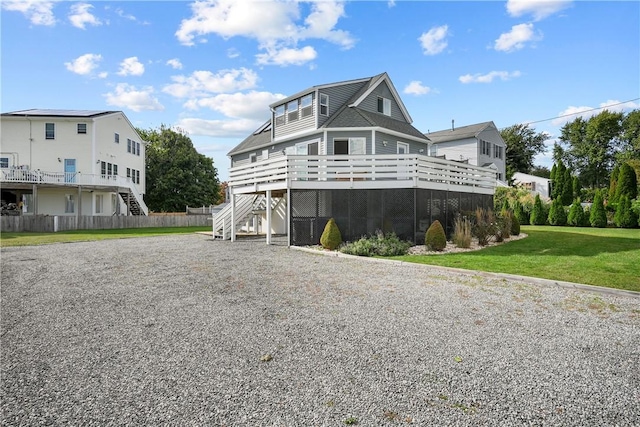 view of home's exterior featuring a lawn and a wooden deck