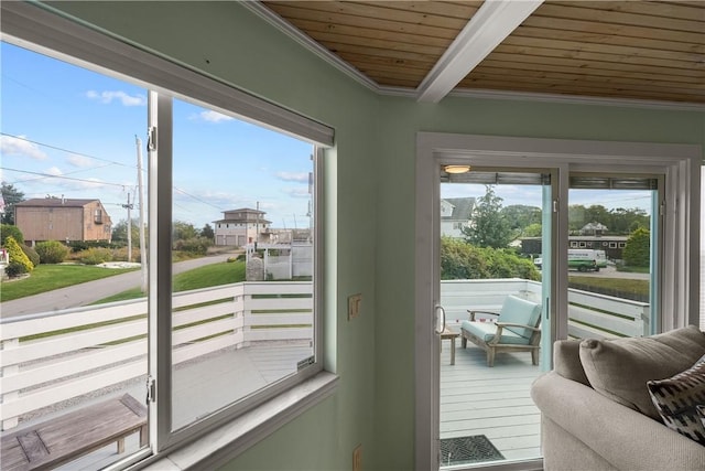 doorway to outside with beamed ceiling, wooden ceiling, and ornamental molding