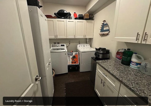 laundry area with washer and clothes dryer and cabinets