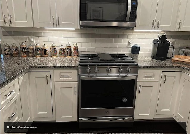 kitchen with decorative backsplash, stainless steel appliances, and white cabinetry