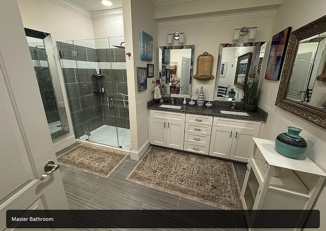 bathroom featuring tile patterned flooring, vanity, a shower with shower door, and ornamental molding