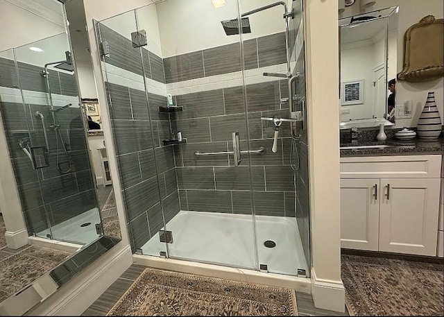 bathroom featuring vanity and a shower with shower door