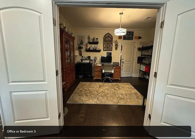 office space with crown molding and dark wood-type flooring