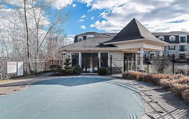 back of property with french doors, a patio area, and a community pool