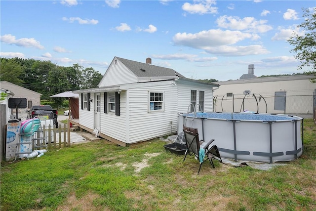 back of property featuring a lawn