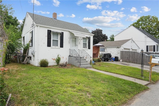 bungalow-style home featuring a front yard