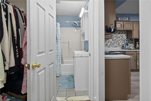 bathroom featuring tile patterned flooring, decorative backsplash, shower / bath combo, and vanity