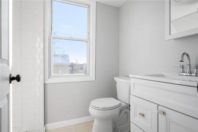 bathroom featuring toilet, tile patterned flooring, and vanity