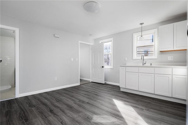 kitchen featuring stainless steel appliances, a baseboard heating unit, dark hardwood / wood-style flooring, and white cabinetry