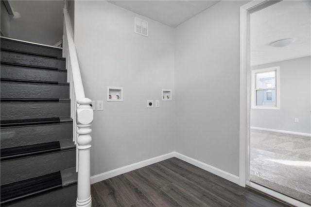 washroom featuring dark wood-type flooring, hookup for a washing machine, and hookup for an electric dryer