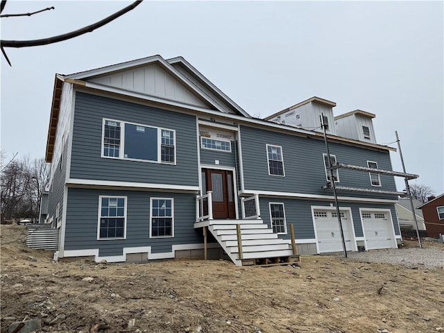 rear view of house with a garage