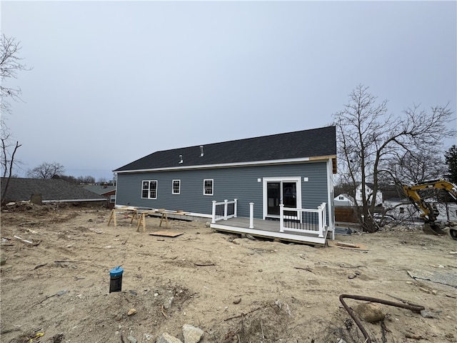 rear view of house featuring a deck